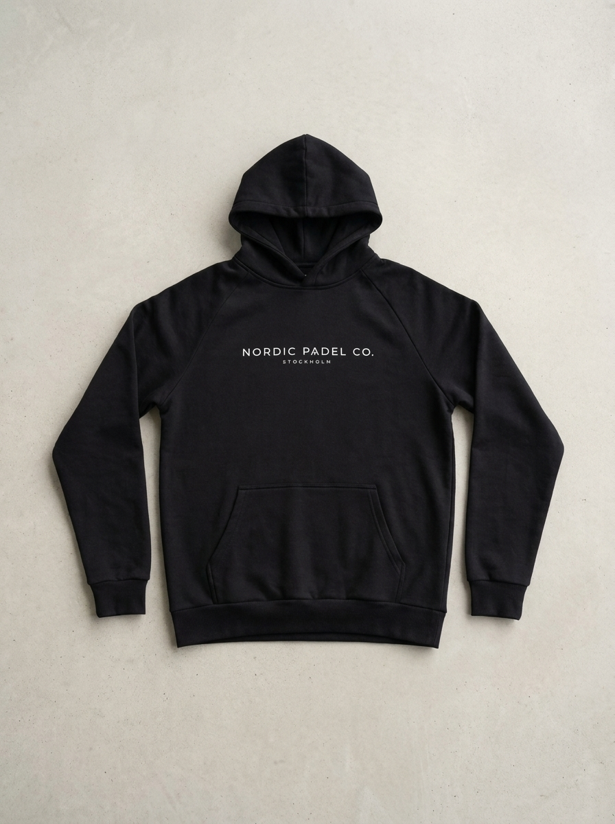 Nordic Padel Co. black hoodie on concrete